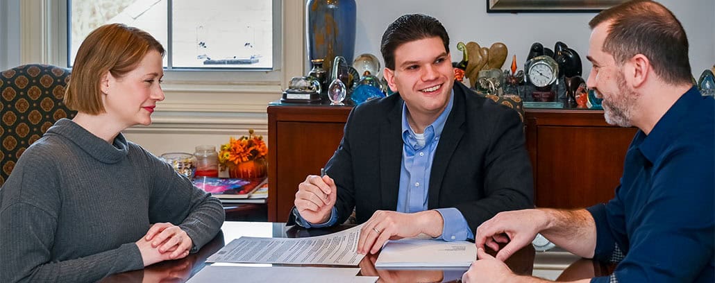 Buyers at closing attorney office with documents.