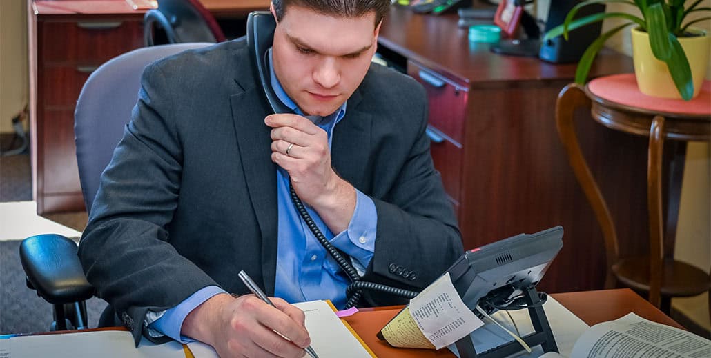 Real Estate lawyer consulting with client on the phone.